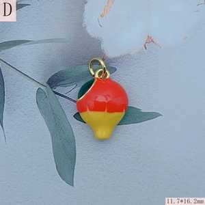 Macro shot of 11.7x16.2mm red enamel fruit pendant with gold loop for DIY jewelry