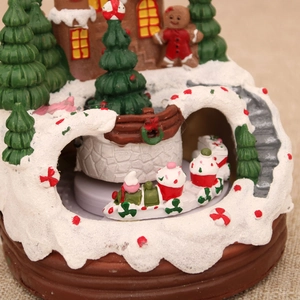Detailed close-up of resin gingerbread house with rotating Christmas train ornament