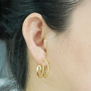 18K gold plated stainless steel double hoop earrings with bead texture on model