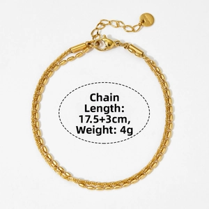 Detail of gold double-layer chain bracelet with bead design and lobster clasp closure