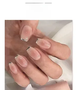 Close-up of French short trapezoid press-on nails with silver metallic tips and pink gradient