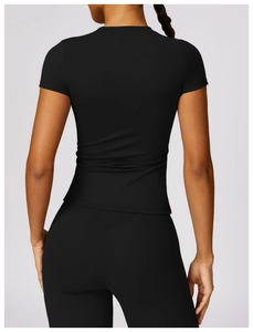 Back view of slim-fit black short sleeve yoga top and high-waist sports leggings for women