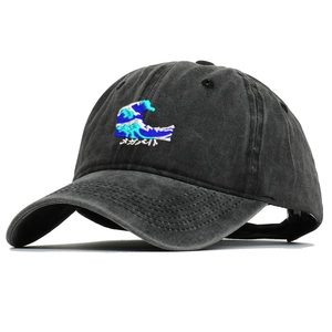 Detailed embroidery of wave pattern and Japanese text on a washed cotton baseball cap