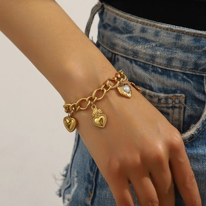 Vintage gold stainless steel heart charm bracelet featuring a central moonstone inlay