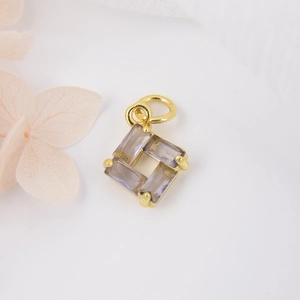 Detailed view of light purple square zircon pendant with gold plating and pink petals