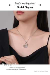Detail of silver heart pendant featuring rose and girl figure on a thin chain link