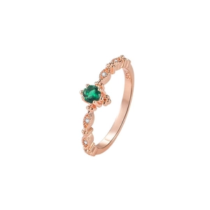 Elegant 14k rose gold ring featuring a green emerald center stone and small white diamonds
