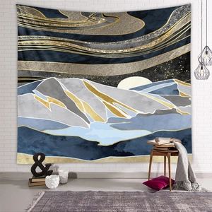 Detail of mountain tapestry with gold accents on white brick wall in a cozy room