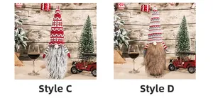 Close-up of knit Christmas gnomes C and D with snowflakes and wavy patterns on wood