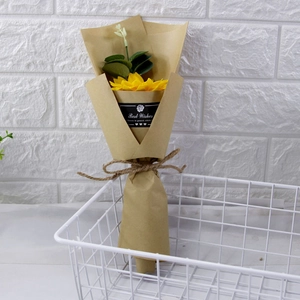 Detail of single sunflower soap bouquet in kraft paper with Best Wishes label