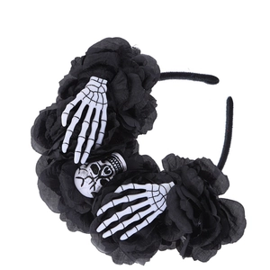 Detail of Halloween headband with black fabric roses and white plastic skulls hands