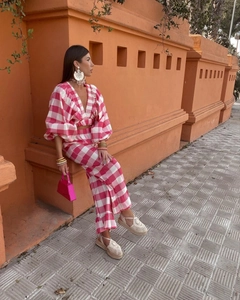 Detail view of pink gingham V-neck crop top and pants set with stylish summer accessories