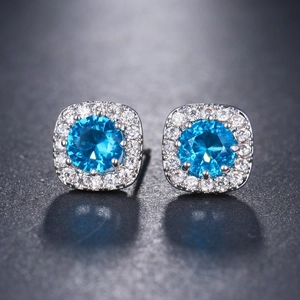 Elegant halo stud earrings featuring round sea blue cubic zirconia in silver setting