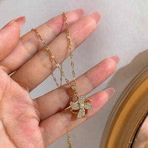 Rotating windmill pendant necklace in gold finish with sparkling pavé cubic zirconia crystals