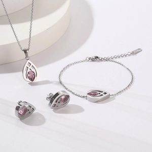 Detailed set of silver jewelry with purple teardrop gemstones on a white background