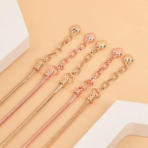 Detailed view of adjustable snake bone bracelets in gold, rose gold and silver finishes