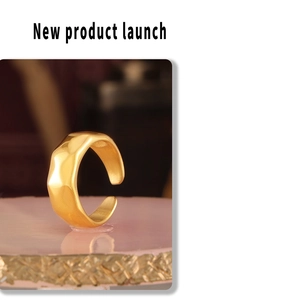 Detail of 18k gold plated hammered texture open ring on a pink display stand