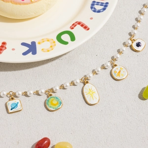 Detailed view of 18K gold stainless steel pendants with Van Gogh style enamel patterns