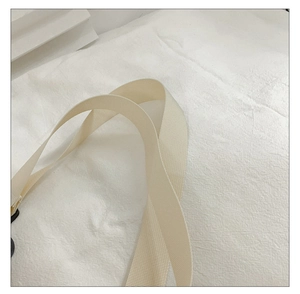 Macro detail of high-density cream nylon webbing strap on this casual bucket bag