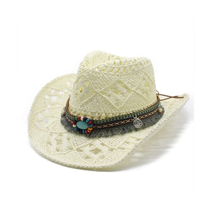 Detail of bohemian straw hat with diamond cut-outs, turquoise beads and ethnic tassels