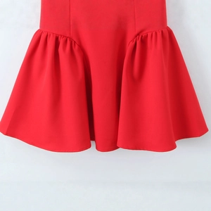 Red ruched sleeveless mini dress with pleated ruffle hem detail on white background