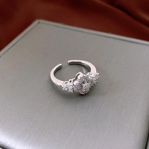 Macro shot of silver clover ring with mother of pearl and pave cubic zirconia stones