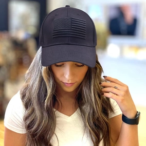 Deep grey baseball cap with embossed American flag detail worn by a model