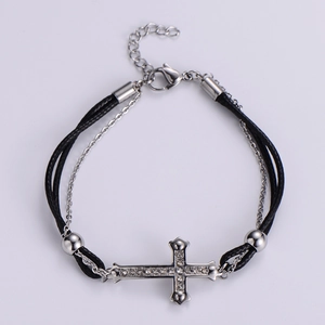 Detail of double-layer titanium steel bracelet featuring a crystal cross and black rope