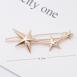 Close-up of golden alloy star hair clip featuring a meteor design with three pentagrams