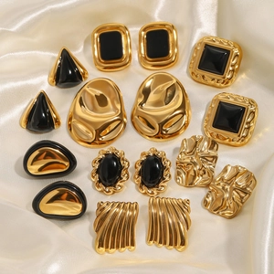 Vintage gold and black enamel stainless steel earrings set on white satin background