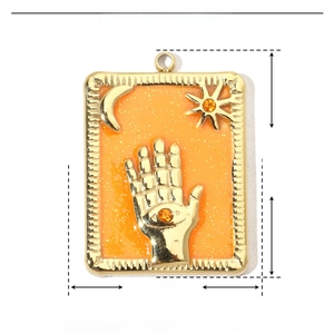 Detailed size chart of a golden rectangular pendant with Hand of Fatima and star patterns