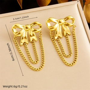 Detail view of gold bow tassel earrings with dimensions 3.1cm width and 6cm length