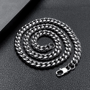 Polished silver stainless steel Cuban link chain necklace with lobster clasp on dark background