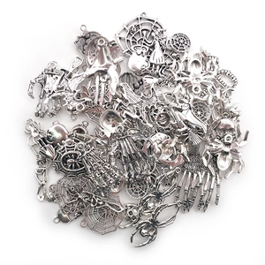 Macro view of assorted silver Halloween metal charms with spider skull and bat motifs