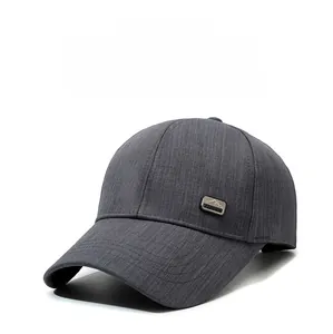 Detail of dark grey baseball cap with textured fabric and mountain logo badge