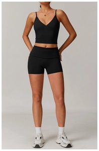 Detail of a black V-neck yoga tank top and high-waist shorts set in premium elastic fabric
