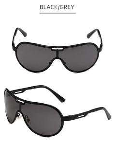 Detail view of oversized retro aviator sunglasses featuring black frames and gray lenses