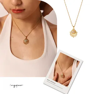 Detailed view of a gold French vintage sunburst pendant necklace with zircon stone inlay