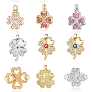 Golden and silver clover charms with colorful cubic zirconia and evil eye details