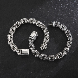 Punk style silver skull bracelet with layered chain and retro polished finish for men