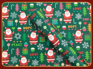 Detail of Christmas gift wrapping paper with Santa patterns and festive holiday greetings