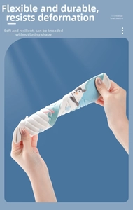 Flexible EVA toilet seat cover with cute penguin print being twisted to show durability