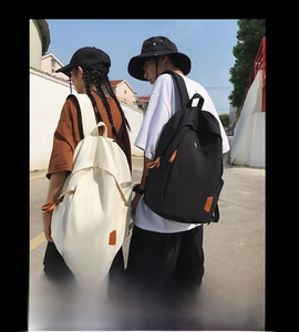 Outdoor street photography showing black and cream backpacks for students and travel