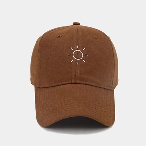 Close-up of brown cotton baseball cap with white sun embroidery and six-panel structure
