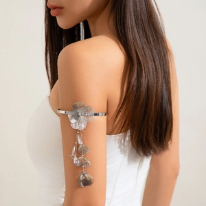 Detail of silver ginkgo leaf tassel arm cuff with flower pendant on model arm