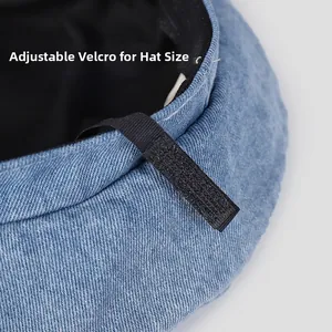 Detail view of denim beret featuring an adjustable internal Velcro strap for custom fit