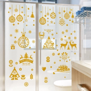 Close-up of gold glitter Christmas wall stickers featuring Santa and snowflakes on glass