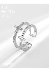 Detail of silver double-layered open ring featuring a sparkling zircon cross and polished cross