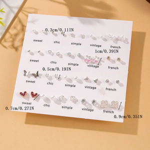 Detail view of 20-pair stud earring set with pearl heart and butterfly designs