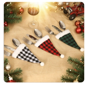 Three-piece Christmas plaid cutlery holders featuring festive red, black, and green hat designs